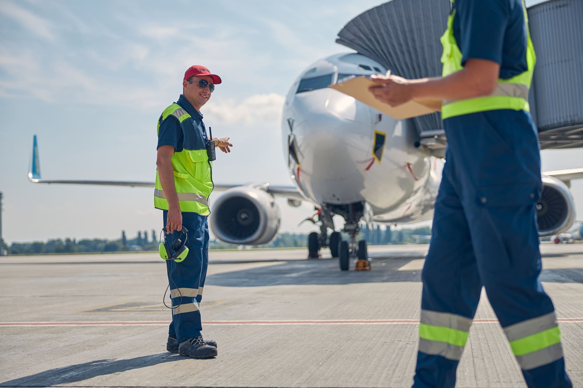 Aircraft maintenance supervisor talking to a mechanic