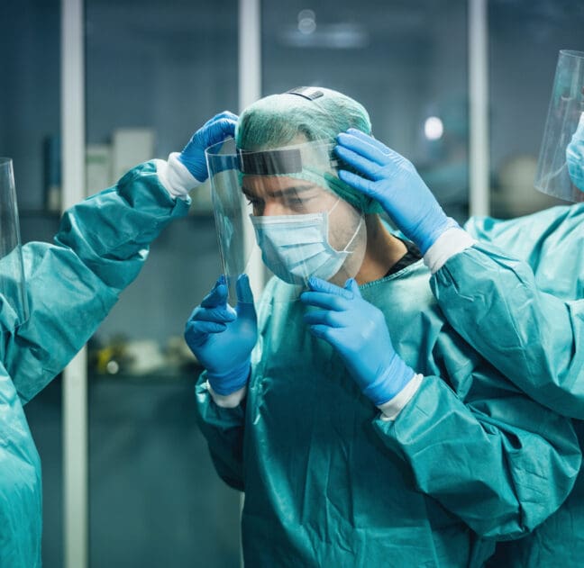 Doctors wearing ppe equipment face surgical mask and visor fighting against corona virus outbreak - Health care and medical workers concept